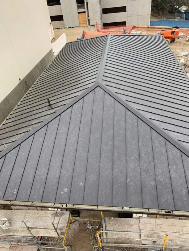 Commercial metal roof construction with crane equipment in Long Beach